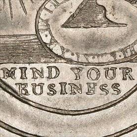 coin with the words mind your business on it